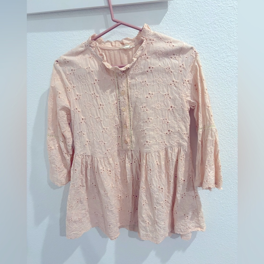 Romantic eyelet rose blouse with bell sleeves.